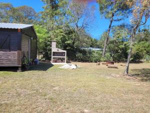 a shed with a sign in a yard at La cabaña 2 dormitorios in Ocean Park +3 photos