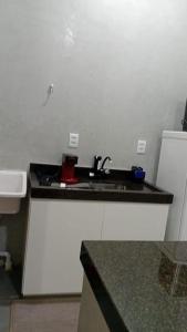 a bathroom with a sink and a counter top at Studio 4 - Solteiro in Aracruz