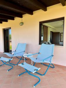 a pair of blue chairs sitting on a patio at BLUE APARTMENT in VILLA ANGISI in Drapia +23 photos