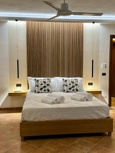 a bedroom with a bed with towels on it at BLUE APARTMENT in VILLA ANGISI in Drapia