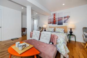 a bedroom with a bed and a couch and a table at Huh's Lodge in San Francisco