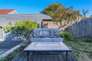 a blue couch with pillows sitting on a wooden deck at Huh's Lodge in San Francisco