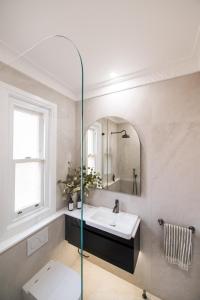 a bathroom with a sink and a mirror at Manly Waterfront Apartment Harbourside in Sydney +9 photos
