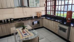 a kitchen with a table with a potted plant on it at Premium house with pool in Santana do Livramento