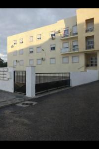 a large building with a fence in front of it at Casa do Paraíso in Elvas