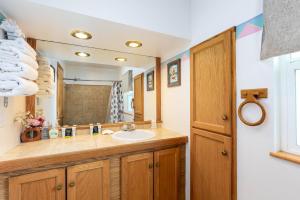 a bathroom with a sink and a mirror at Cascade Motel in Oakridge +17 photos