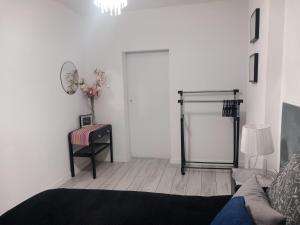 a living room with a couch and a table and a mirror at Apartament z kominkiem RetroGlam in Mieroszów