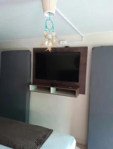 a flat screen tv on a wall in a room at Recanto Romig in Pomerode