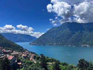 a view of a lake with mountains in the background at Lake Como Ti Amo - Rooftop Pool to share in Nesso