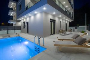 a swimming pool in the backyard of a house at Pomaria Boutique Residences in Lefkada