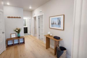 a living room with white walls and a wooden table at Helling Circle Hideaway 303 in Heber City