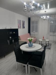 a living room with a table and chairs and a couch at Apartament z kominkiem RetroGlam in Mieroszów +34 photos