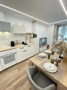 a kitchen with a table with plates on it at Pontevedra Apartments -New Loft Centro Pontevedra in Pontevedra