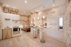 a kitchen with a counter and a table in a room at Old tuff apartments in Polignano a Mare +17 photos