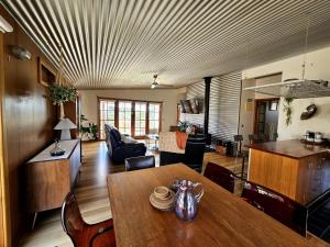a living room with a table and a dining room at Cedar Hill Retreat in Venus Bay