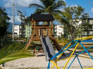 a playground with a slide and a play structure at East Lake Oasis in Arima