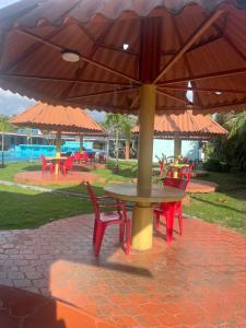 a table and chairs under a large umbrella at Marvella Club in Nueva Gorgona