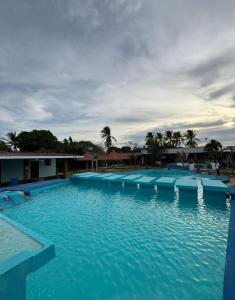 a large swimming pool with blue water in a resort at Marvella Club in Nueva Gorgona
