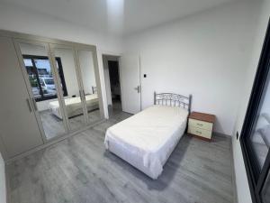 a bedroom with a bed and a large mirror at Joy Residence- 3 bedroom apartment with balcony in Nicosia