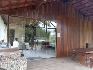 a room with sliding glass doors in a house at Casa Recanto do Sossego in Antonina