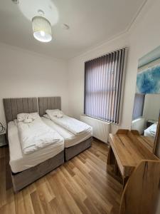 a bedroom with a bed and a table in it at MK Apartments, Chorlton, Manchester Car Park in Manchester