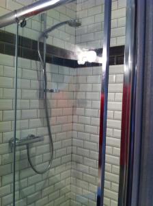 a shower with a shower head in a bathroom at COMME chez VOUS in Saint-Satur +13 photos