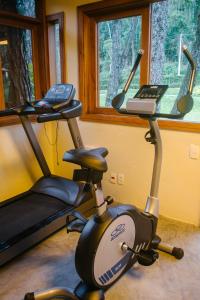 a exercise bike in a room with a window at Pousada Tucano Do Cuiabá in Itaipava