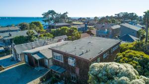 an aerial view of a house with the ocean behind it at East Side Beach House in Santa Cruz