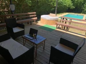 a patio with a bench and a table with a laptop at Cabaña Vista Las Bravas in Recinto