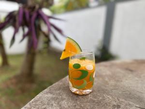 a glass with a drink with a lime in it at Zuulas Palace in Dickwella