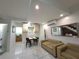 a living room with a couch and a table at Abode86-PGT Townhouse2 in Lapu Lapu City