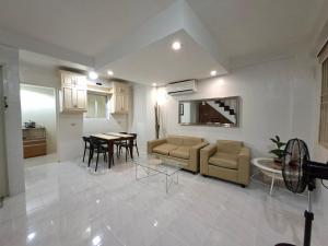 a living room with a couch and a table at Abode86-PGT Townhouse2 in Lapu Lapu City