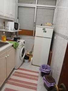 a kitchen with a refrigerator and a washing machine at Benfica in Lisbon