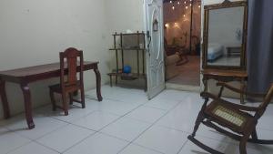 a room with a table and chairs and a mirror at Hostal Brisas del Ometepe in Rivas