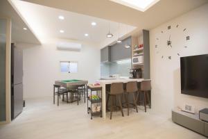 a kitchen and dining room with a table and chairs at T and C 民宿 in Wujie