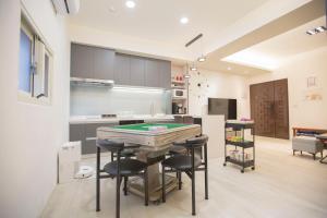 a kitchen with a ping pong table in a room at T and C 民宿 in Wujie