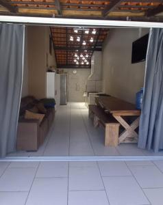 a living room with a couch and a table at HosteldaRo in Penha