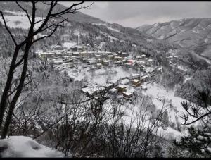 a town is covered in snow on a mountain at L'Antica Locanda da Gigino in Corniolo