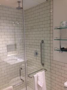 a bathroom with a glass shower with towels at Hollywood Hotel in Los Angeles