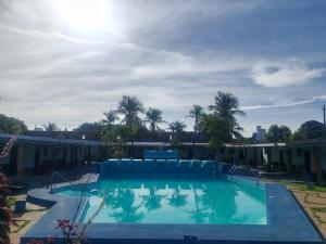 a large swimming pool with palm trees in the background at Marvella Club in Nueva Gorgona