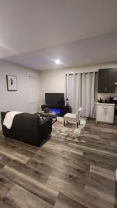 a living room with a couch and a table at Hebzibah's Luxe in Prince George +24 photos