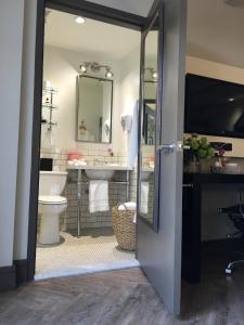 a bathroom with a sink and a toilet and a mirror at Hollywood Hotel in Los Angeles