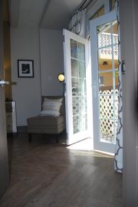 an open door to a room with a chair and a window at Hollywood Hotel in Los Angeles