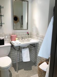 a bathroom with a sink and a toilet and a mirror at Hollywood Hotel in Los Angeles