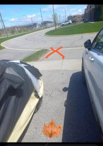 an orange x on the road next to a car at ClassicPavillion INN in Bowmanville