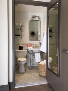 a bathroom with a sink and a toilet and a mirror at Hollywood Hotel in Los Angeles