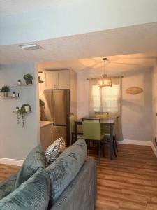 a living room with a couch and a kitchen with a table at Amelia’s Arena Retreat in Orlando