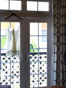 a sliding glass door with clothes hanging on it at Hollywood Hotel in Los Angeles