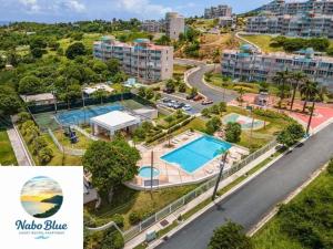 an aerial view of a city with a swimming pool at NaboBlue Ocean View Apartment Maunabo PR in Maunabo