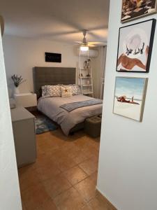 a bedroom with a bed and pictures on the wall at NaboBlue Ocean View Apartment Maunabo PR in Maunabo +61 photos